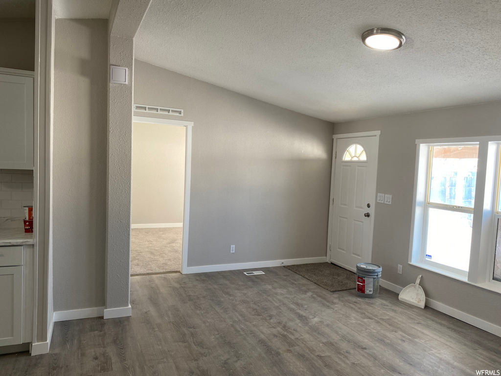 entrance foyer featuring hardwood flooring and natural light