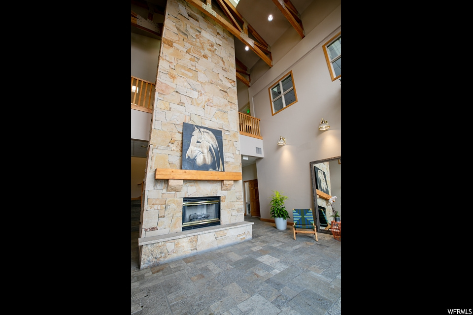 living room with a high ceiling and a fireplace