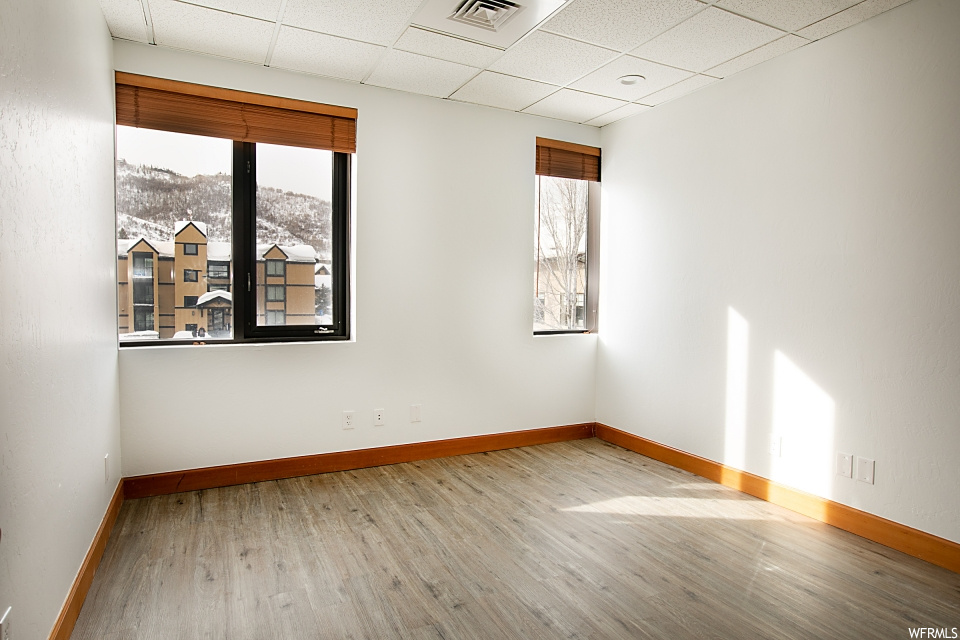 empty room with hardwood flooring and natural light