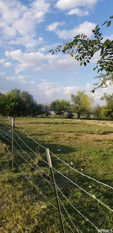 View of yard with a rural view