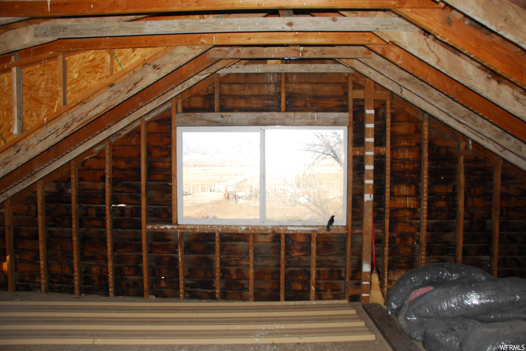 unfinished attic with vaulted ceiling