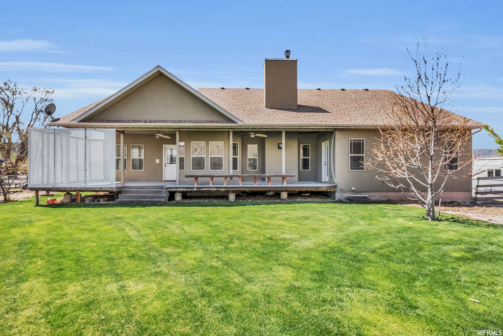 Back of house featuring a lawn