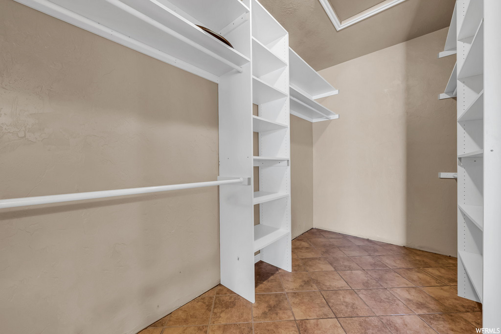 Walk in closet with tile floors