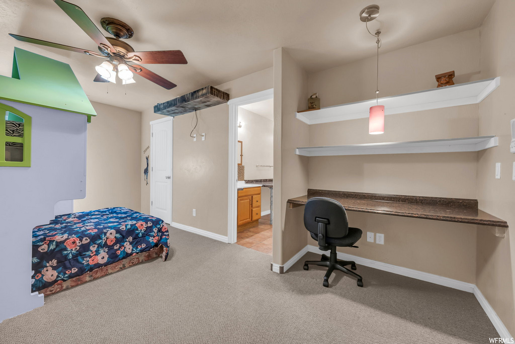 Interior space featuring a ceiling fan and carpet