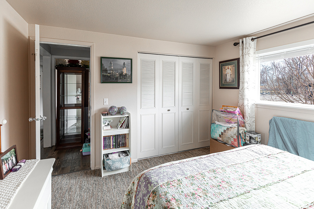 bedroom featuring hardwood flooring and multiple windows