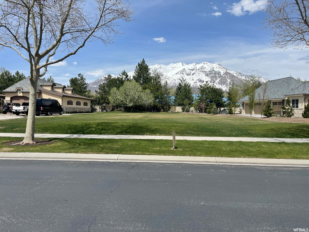 view of front of home with a front lawn and a mountain view