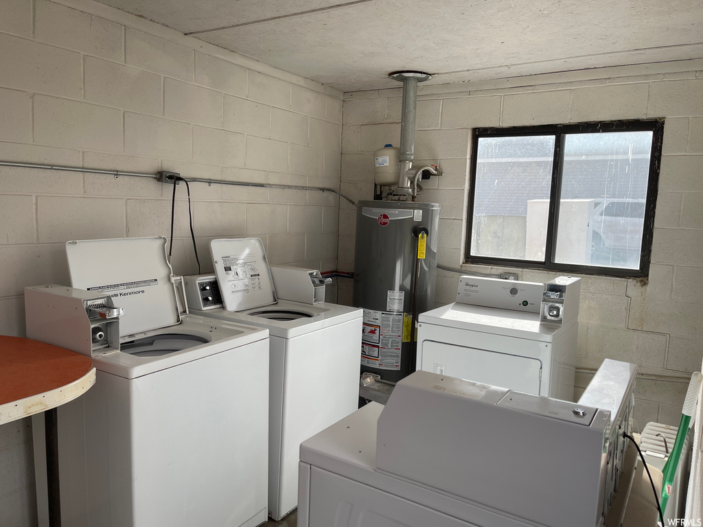 washroom featuring separate washer and dryer and water heater
