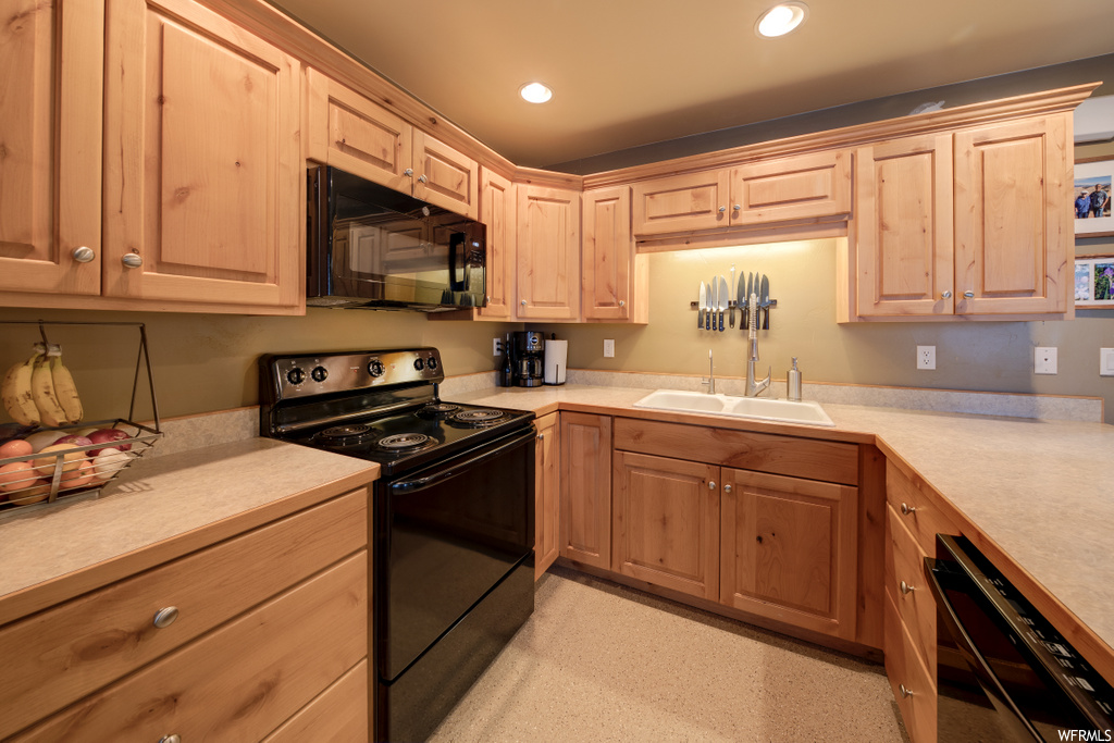 kitchen featuring microwave, dishwasher, electric range oven, brown cabinetry, light countertops, and light floors