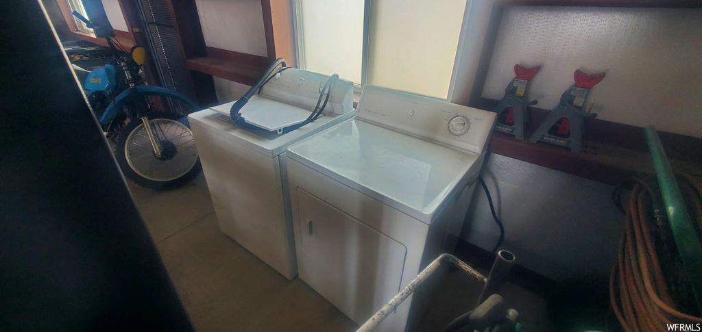clothes washing area featuring washer / dryer