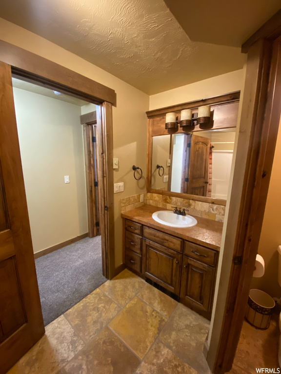 bathroom with tile flooring, mirror, and vanity
