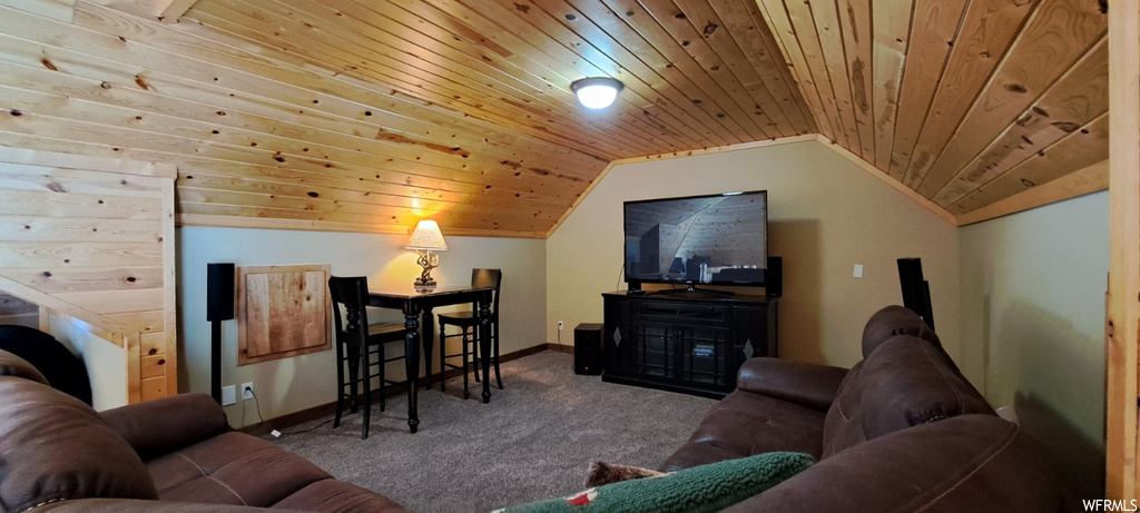carpeted living room featuring lofted ceiling and TV