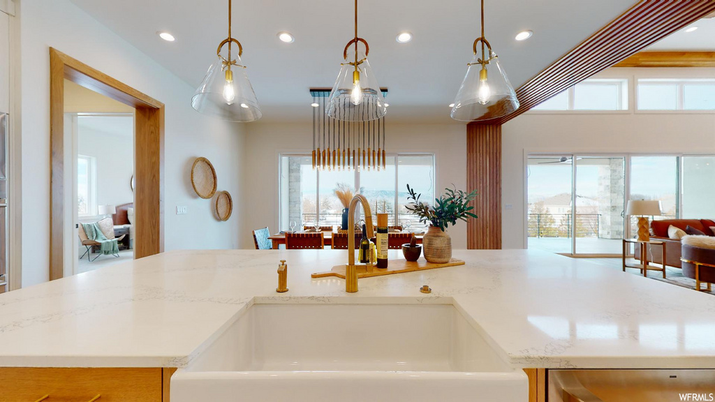 kitchen featuring natural light, pendant lighting, and light countertops