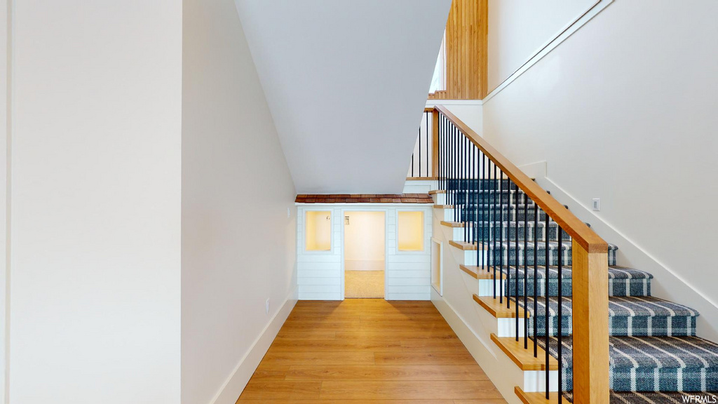 stairway with wood-type flooring