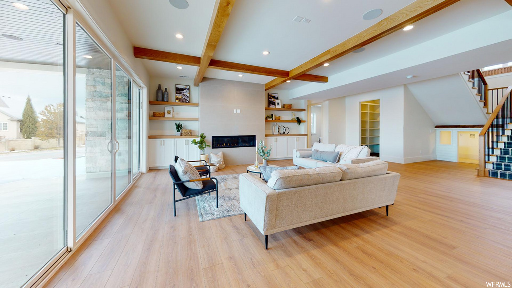 hardwood floored living room with coffered ceiling and beamed ceiling