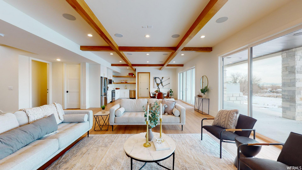 living room with coffered ceiling, wood-type flooring, and beamed ceiling
