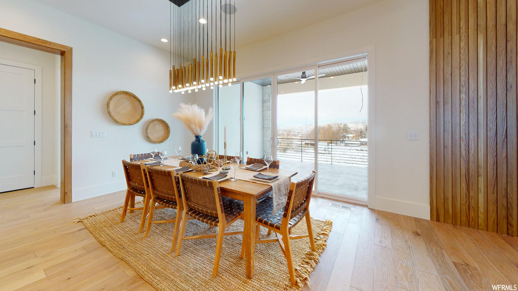 dining space featuring natural light and wood-type flooring