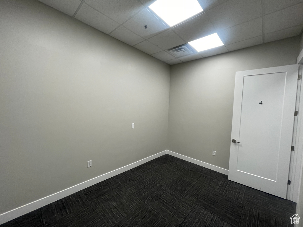 Unfurnished room with a paneled ceiling