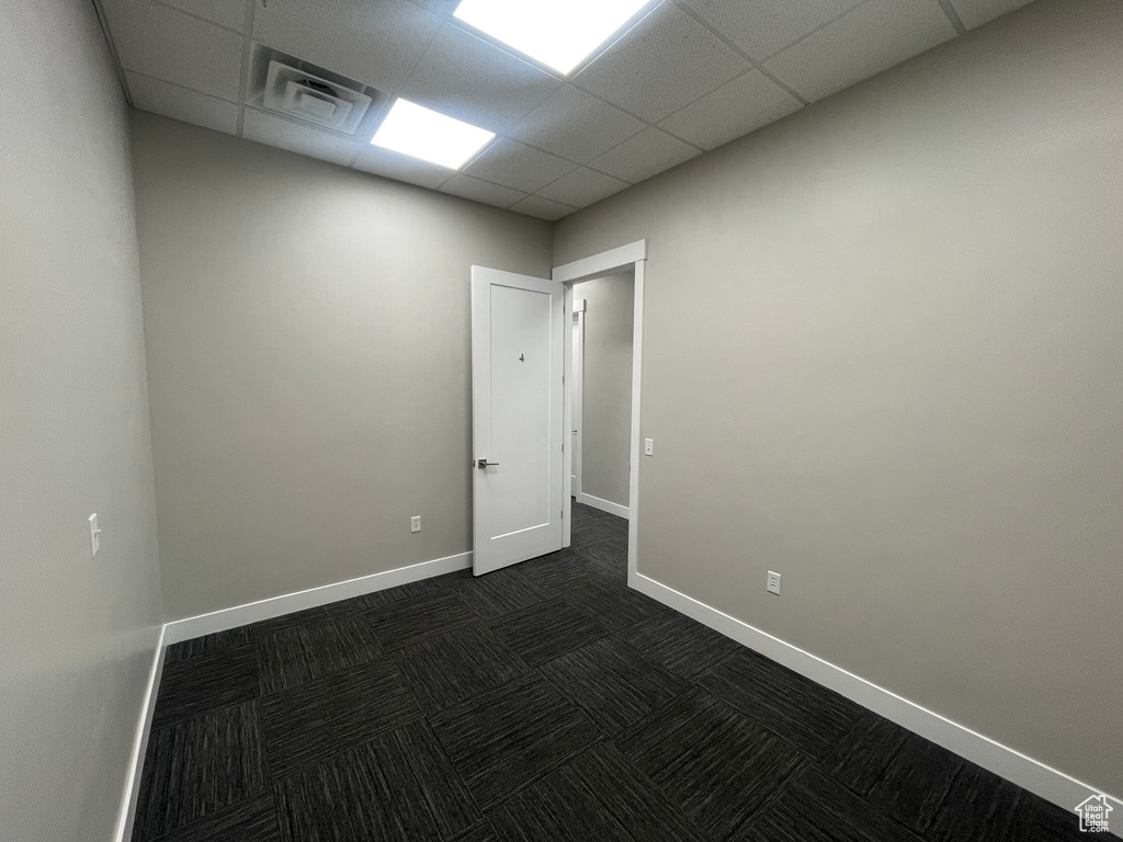 Unfurnished room featuring a drop ceiling