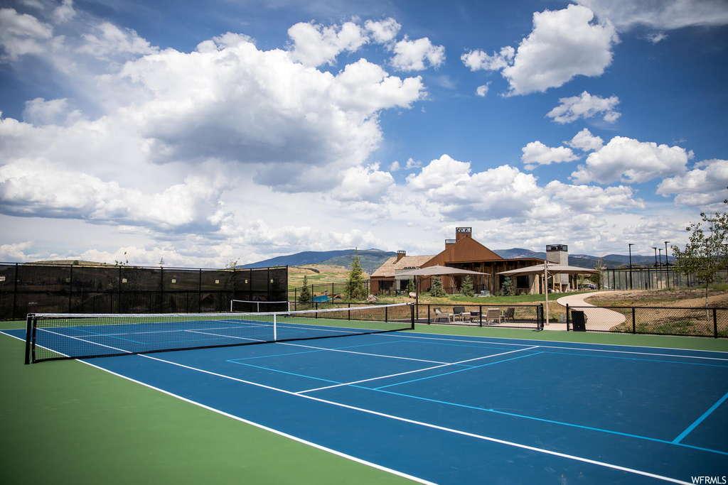 View of tennis court featuring a mountain view