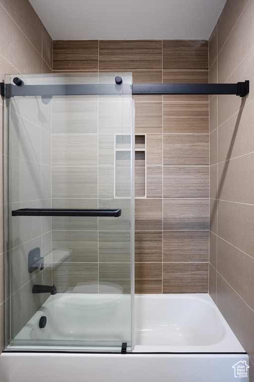 Bathroom with enclosed tub / shower combo