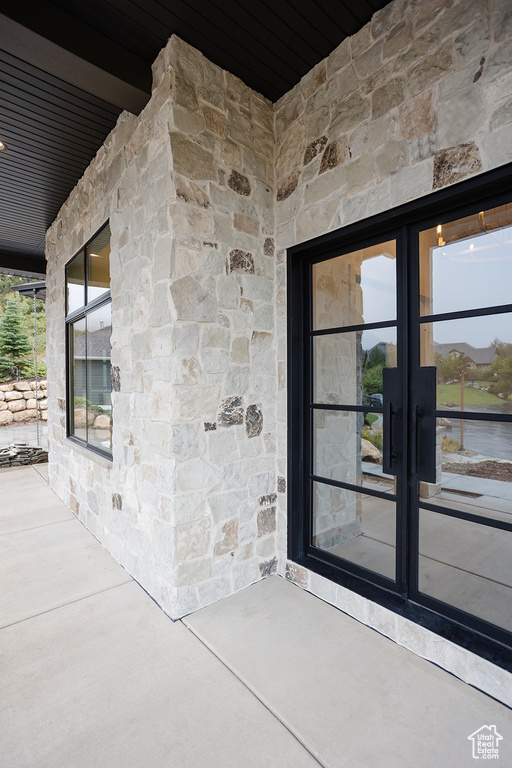 Entrance to property featuring a patio area and french doors