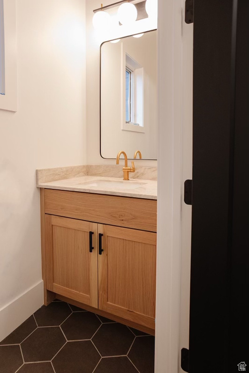 Bathroom featuring vanity and tile flooring
