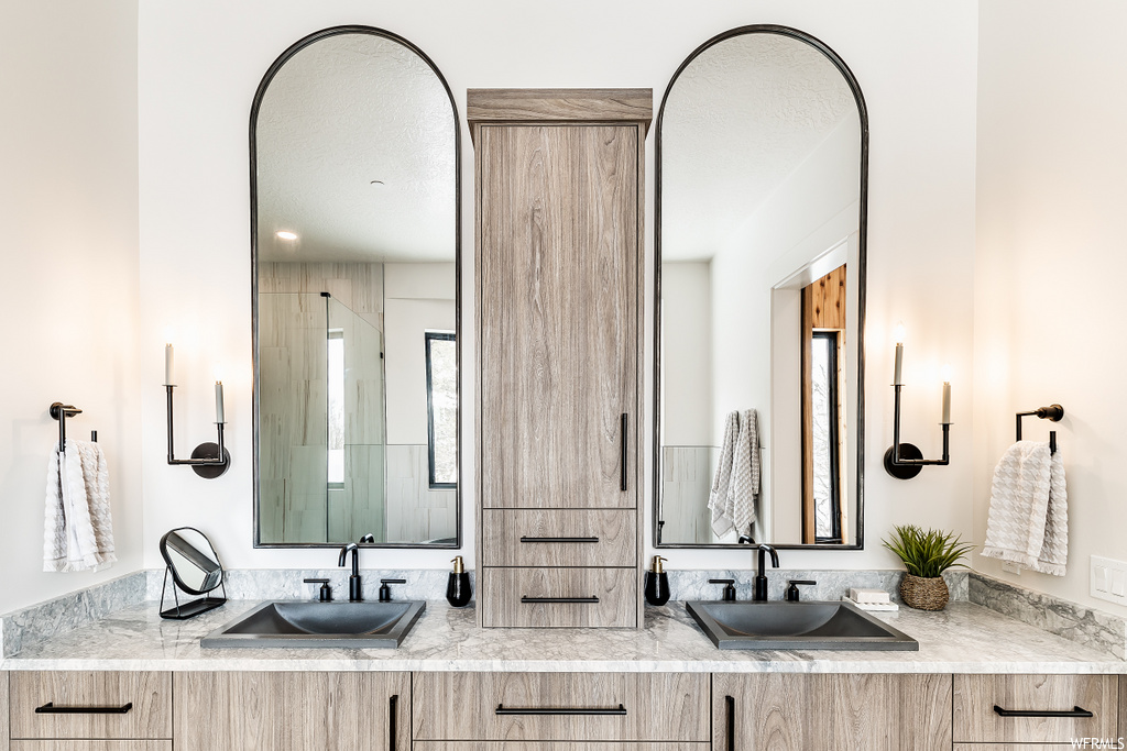 interior space with dual mirrors and double vanities