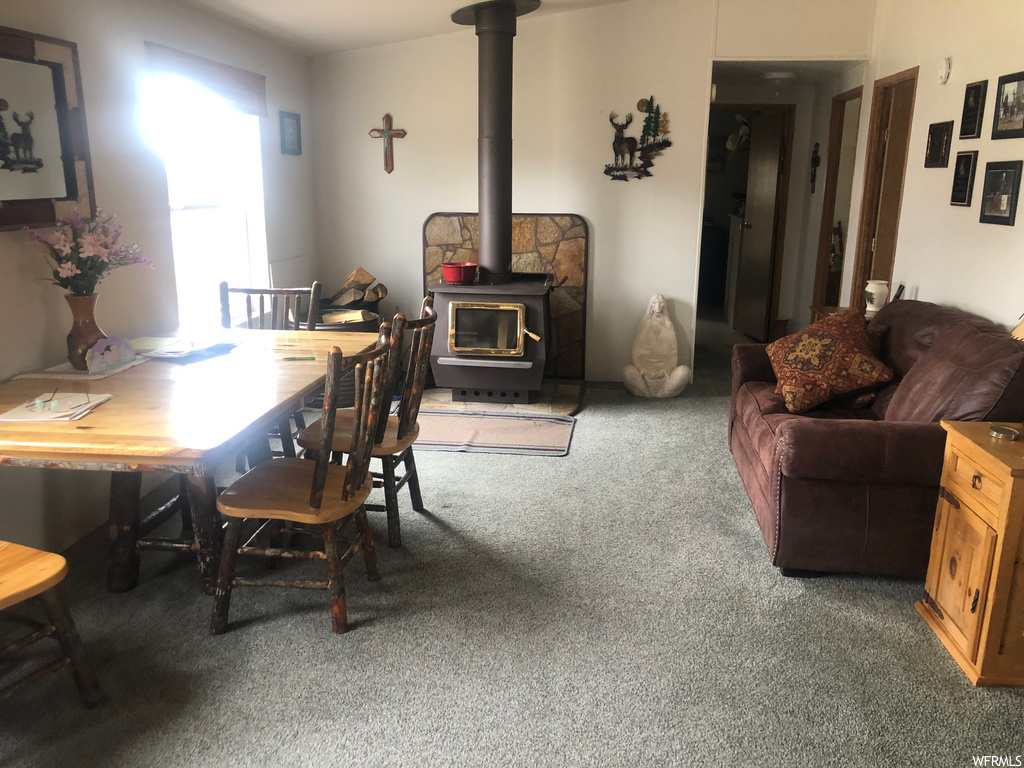 dining room featuring natural light, carpet, and a fireplace