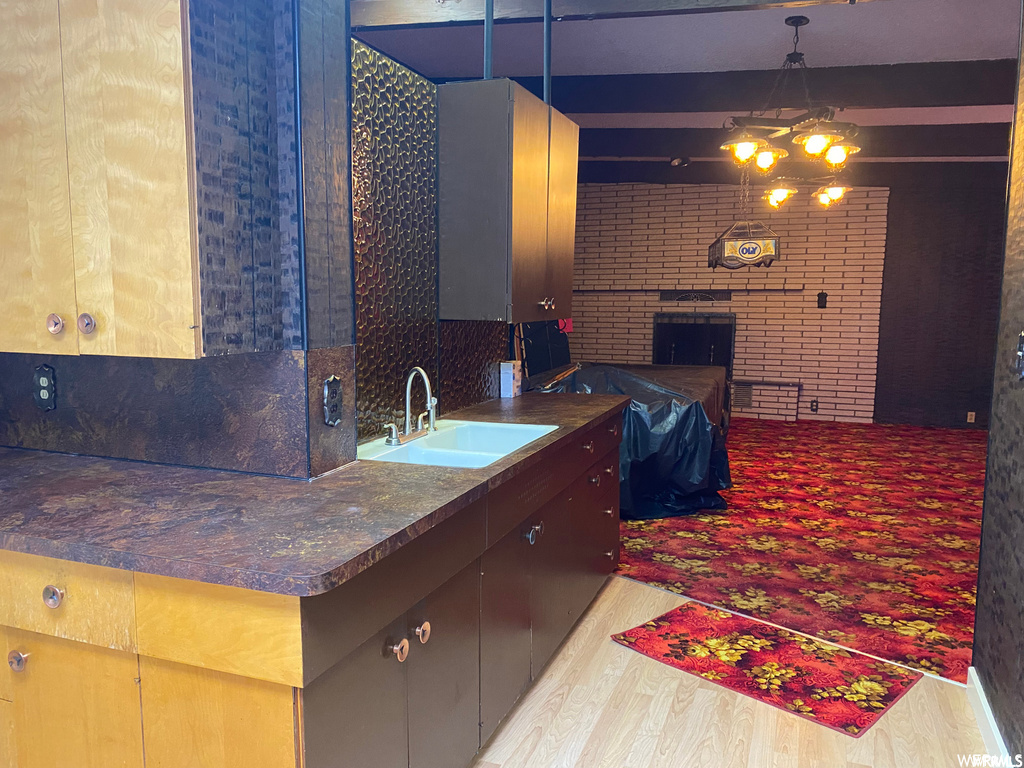 kitchen featuring hardwood floors, dark countertops, and pendant lighting