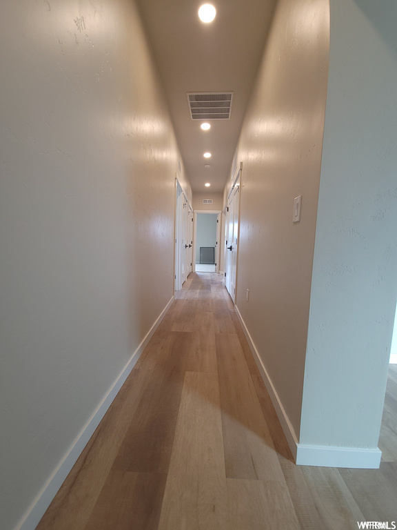 Corridor featuring wood-type flooring
