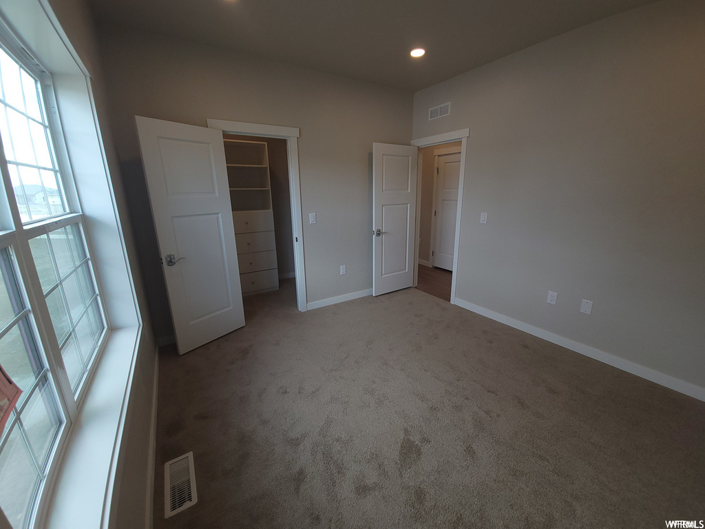 Bedroom featuring carpet and natural light