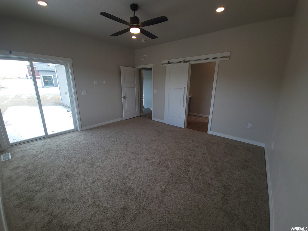Bedroom featuring natural light, carpet, and a ceiling fan