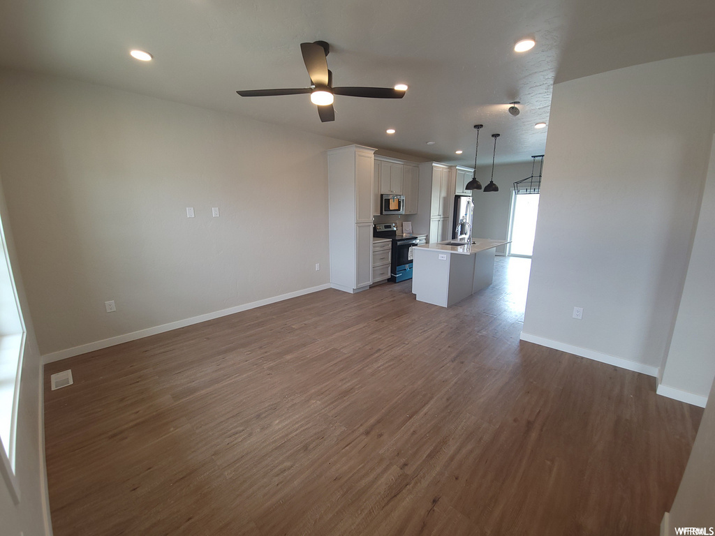 Living room with hardwood flooring and microwave