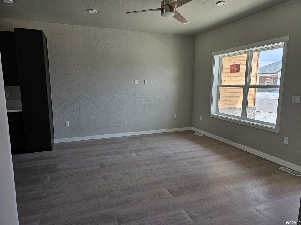 Spare room with ceiling fan and dark hardwood floors