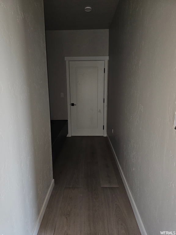 Hallway with dark hardwood flooring