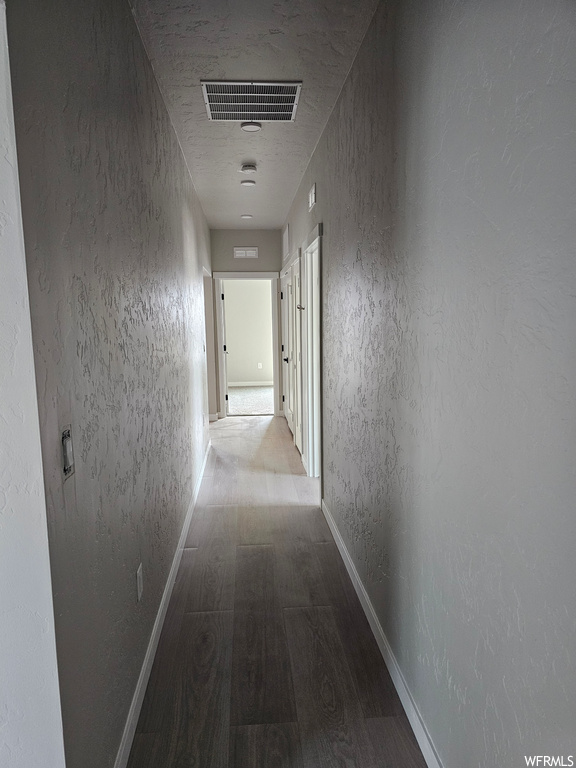 Corridor featuring light hardwood flooring