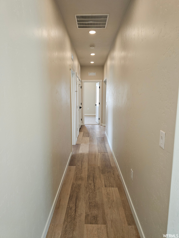 Hallway featuring light parquet floors