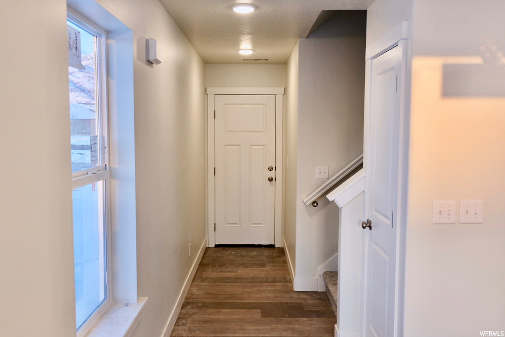 hallway featuring natural light and wood-type flooring
