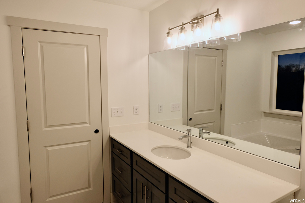bathroom with mirror and large vanity