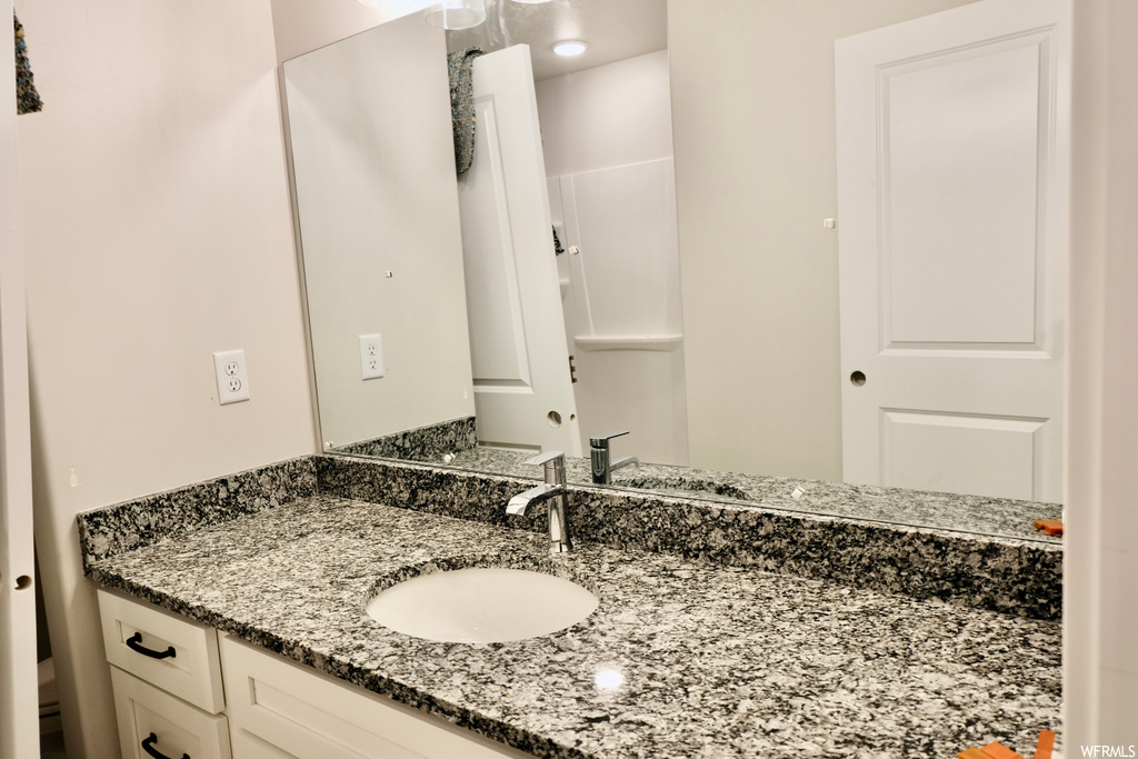 bathroom featuring mirror and vanity