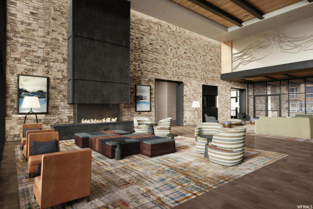 lobby featuring a high ceiling, hardwood flooring, and a fireplace