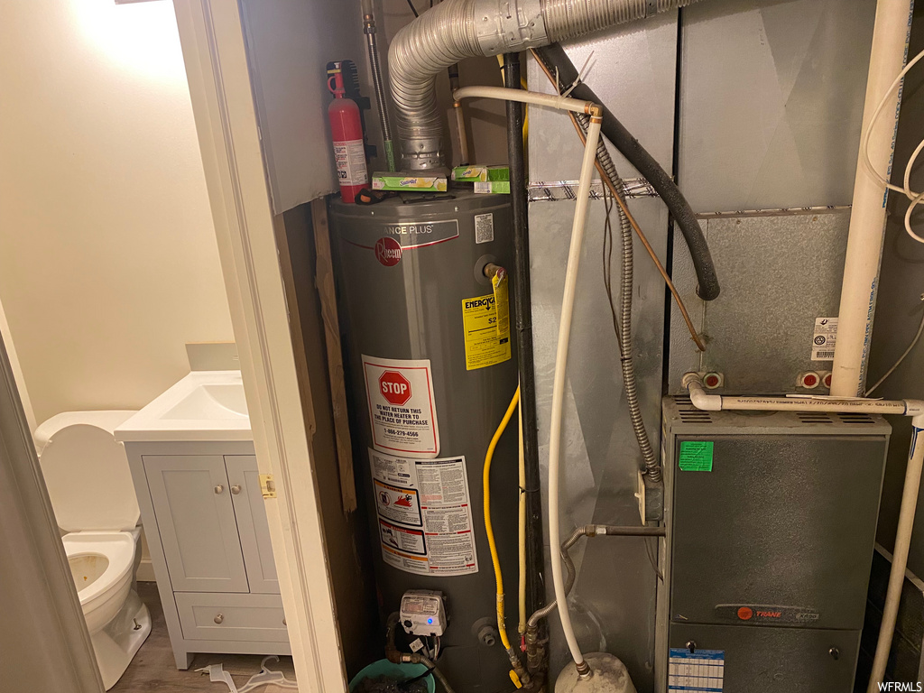 utility room featuring water heater