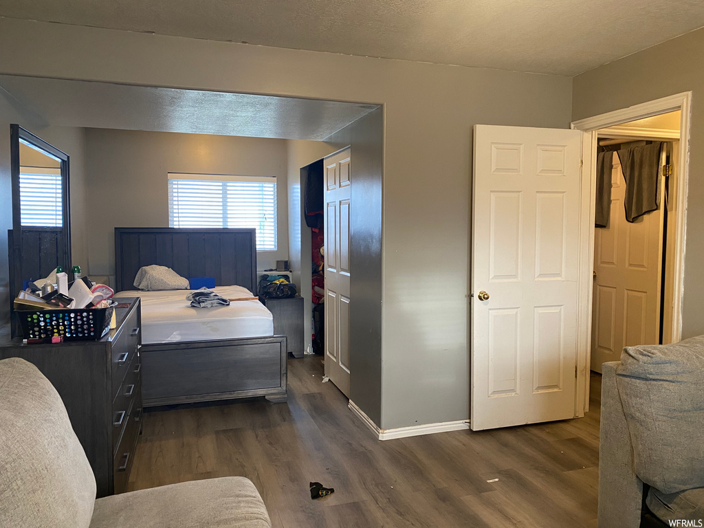 hardwood floored bedroom featuring natural light