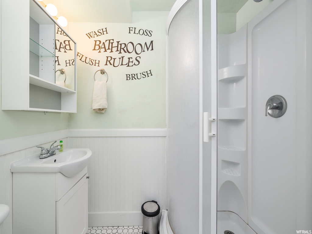 half bathroom featuring mirror, vanity, and toilet