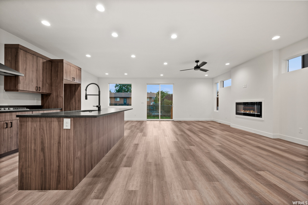 Kitchen featuring ceiling fan and light hardwood flooring