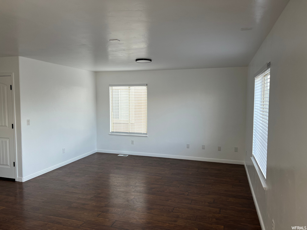 spare room featuring hardwood floors and natural light