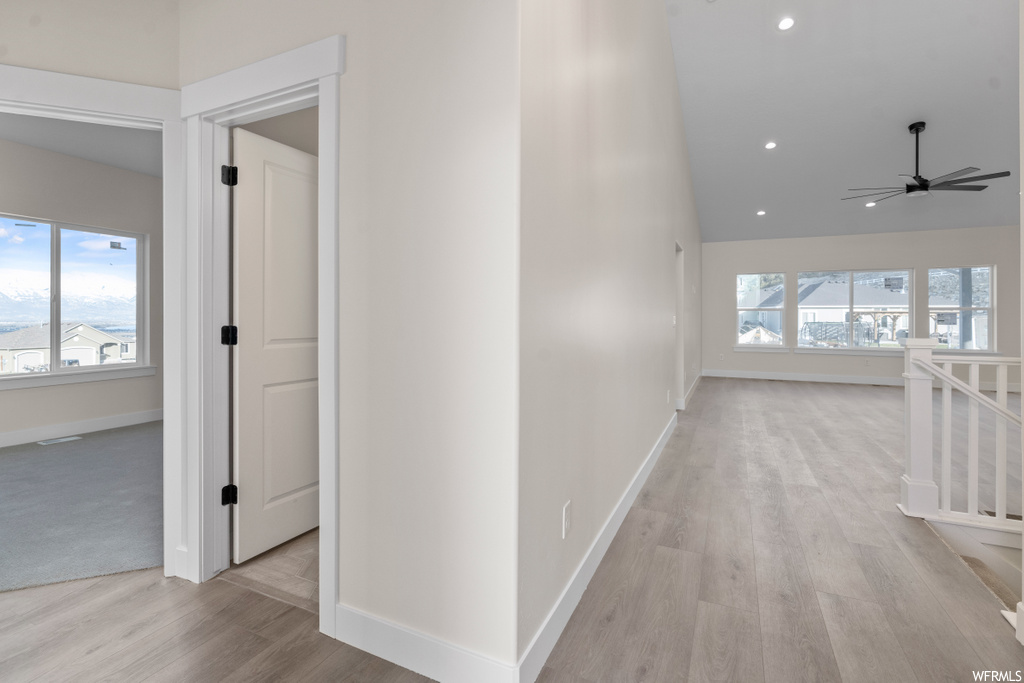corridor with hardwood floors and natural light