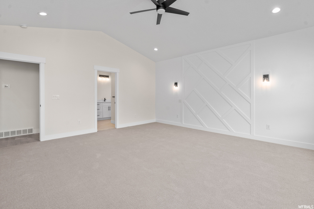 empty room with carpet and vaulted ceiling