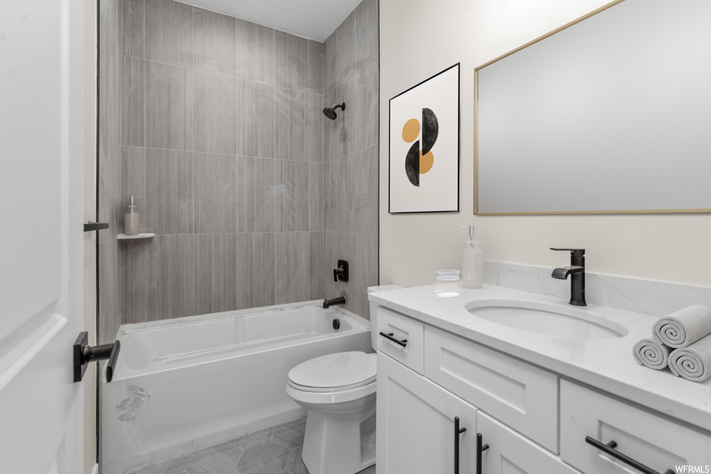 full bathroom with tile flooring, mirror, bathtub / shower combination, toilet, and vanity