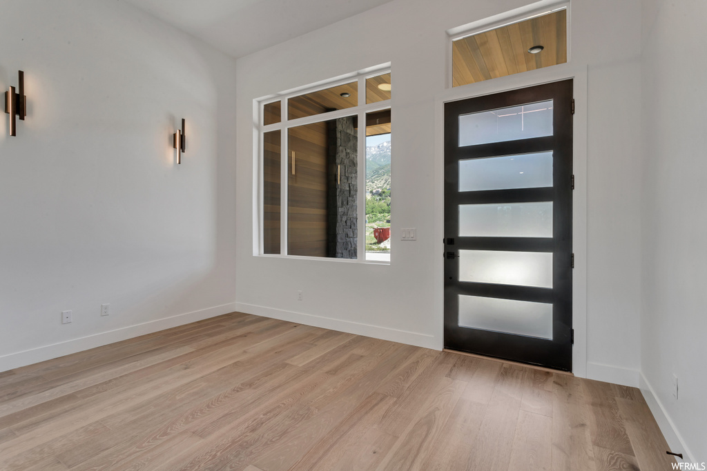 Foyer with light hardwood / wood-style floors